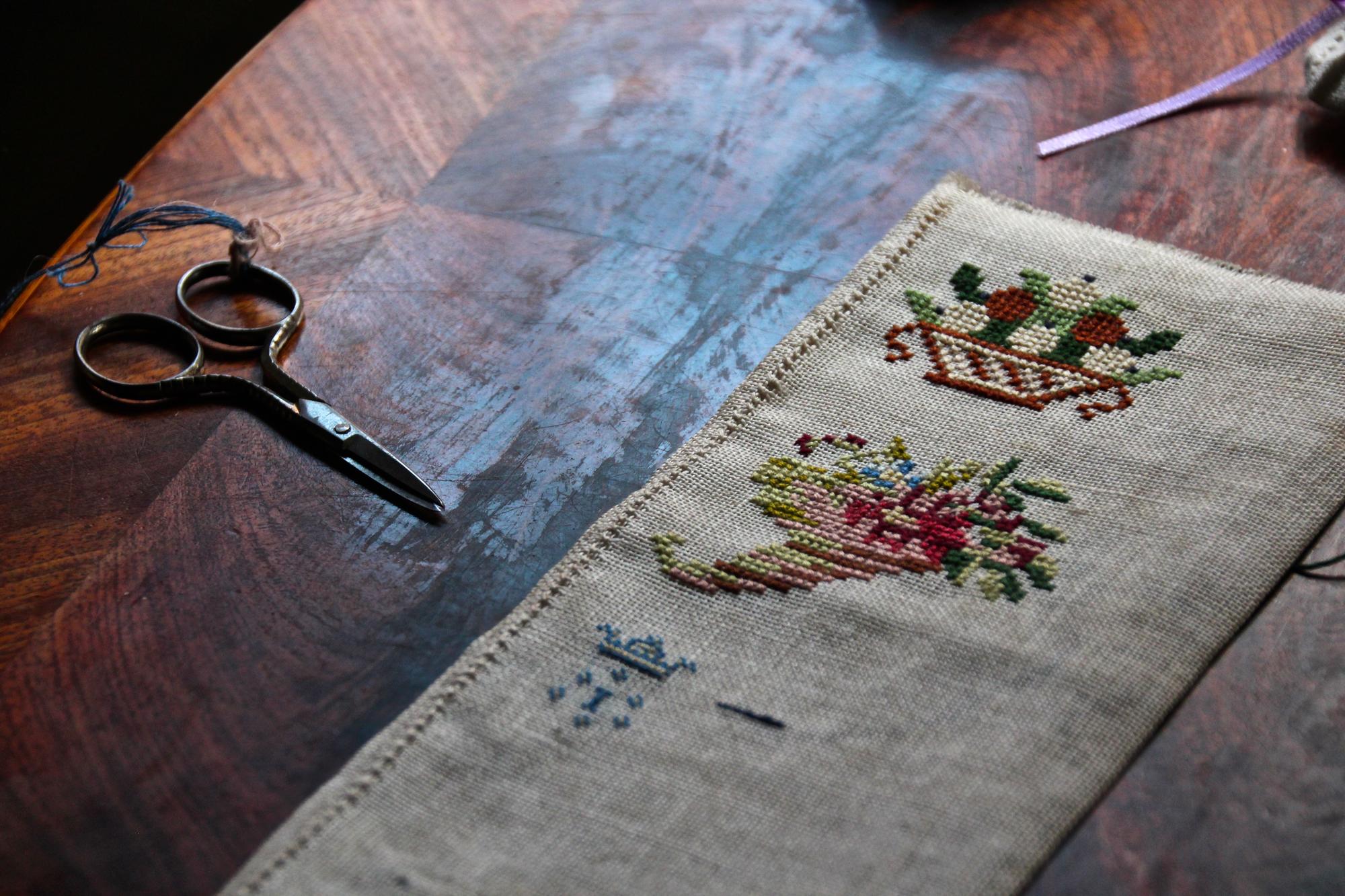 Range of embroidered samples on table